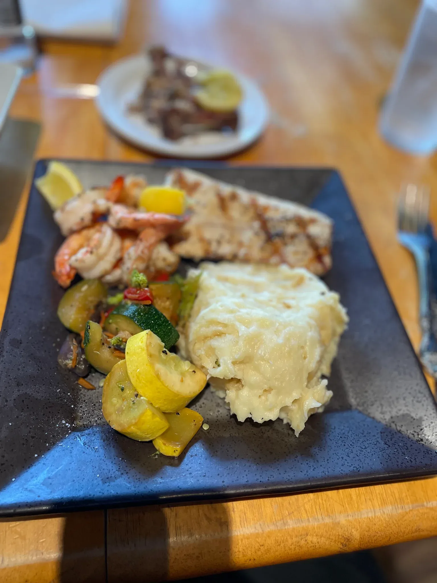 Grilled shrimp and fresh catch platter with mashed potatoes and squash